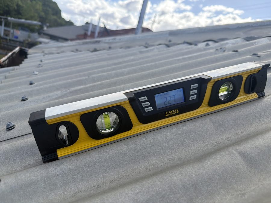 Digital level measuring roof pitch on site